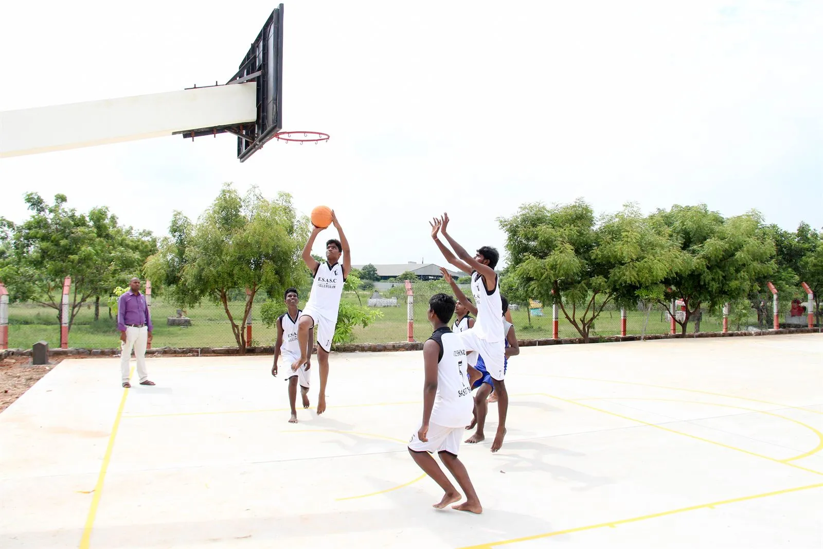 Students playing basketball on the college court